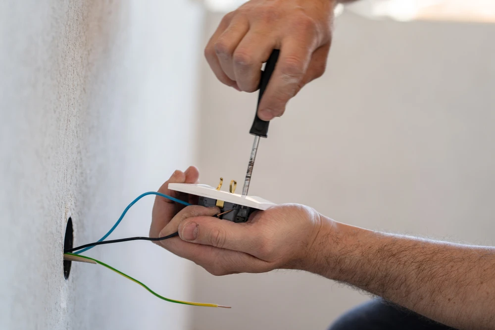 Licensed electrician wiring a power point